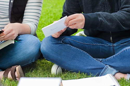 Two students studying flashcards